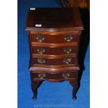 A Mahogany finished four-drawer stationery/bedside Cabinet. 31'' high x 16'' wide x 13'' deep.