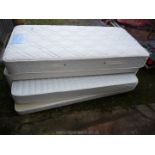 A single guest bed with roll-out spare base and mattress.