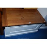 A Pine topped and white painted finish blanket box with raised and fielded front panel,