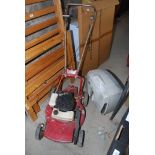 A 4 stroke rotary petrol lawn mower with grass collection box and deflector.