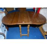 A contemporary Pine curved-ended drop-leaf Kitchen Table, 36'' wide x 60'' long.
