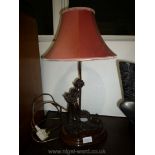 An appealing Table Lamp the base in the form of a heavy bronze coloured figure of a girl in a 3/4