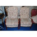 A pair of contemporary hard-wood framed buttoned-back fireside armchairs.