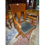 A North American Oak framed Swivel Elbow/Office Chair having a fret-worked splat,