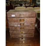 A six drawer cabinet made from hard board, 16" high x 15" wide x 10" deep.