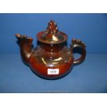 A large brown glazed teapot with spiral decoration to the spout, handle and finial,