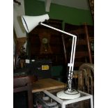 A white angle poise lamp.