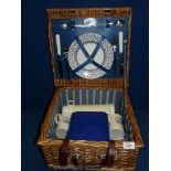 A vintage wicker picnic hamper complete with contents.