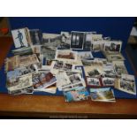 A box of mixed black and white postcards from Europe and London and coloured postcards from Milan,
