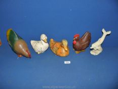 Two wooden chickens, a wooden duck, a china duck and alabaster dolphin.