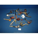 A quantity of pipes including porcelain, wood, leather bound etc.