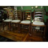 A set of four mixed woods, ladder-back Dining Chairs having woven sea-grass seats, turned legs,