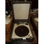 A wind up Record Player in a brown skin case a/f., 15" x 13" x 8".