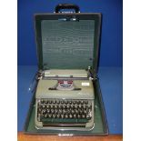 An olive green Olympia typewriter, in black case, a/f.