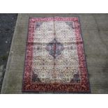 A blue ground Kashmir silk rug having navy whipping and medallion design in cream and blue,