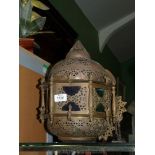 A hanging middle eastern Islamic brass Lantern with coloured glass panels, 14" tall.