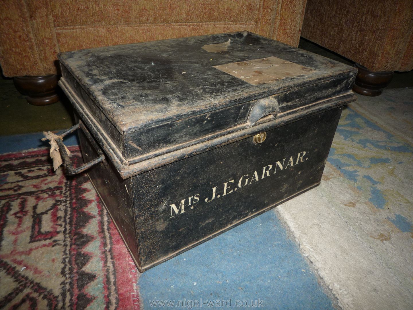 An old black painted steel Deeds Box having swing handles and stencilled to the front with the name