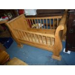 A Child's Vintage French style Honey Pine Cot having sliding action side rails,