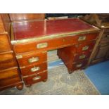 A most appealing Mahogany Campaign type Kneehole Desk having pedestals each with three drawers and