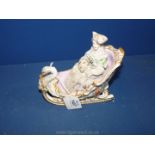 A Frankinsell porcelain figure of a Lady on a sleigh with swan detail and hand painted floral