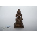 A good Indian post Vijayanagar small bronze figure of a seated deity, probably Krishna,