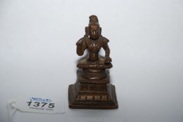 A good Indian post Vijayanagar small bronze figure of a seated deity, probably Krishna,