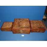 A graduated set of three oriental Camphor wood Boxes with metal clasps (one clasp a/f) and highly