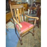 An Oak framed Elbow Chair having turned and lobed front legs,