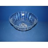 A large footed fruit bowl with fluted rim, 6 1/2'' tall x 13'' diameter.