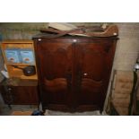 A French Oak Armoire having a pair of opposing doors each with two shaped,