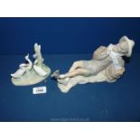 A Lladro figure of boy lying on a haystack with a bird on his foot,