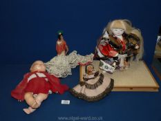 A quantity of dolls including Flamenco dancer on stand, fabric Asian doll, baby doll,