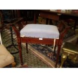 An appealing Edwardian Mahogany Piano Stool standing on tapering square legs with spade feet and