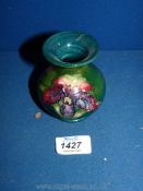 A small Moorcroft green Vase, decorated with irises, 3 1/2" tall.