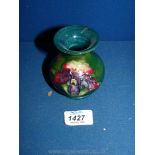 A small Moorcroft green Vase, decorated with irises, 3 1/2" tall.