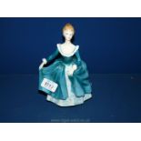 A Royal Doulton figure 'Janine' in turquoise dress, 8 1/2" tall.