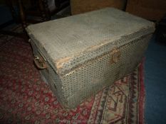 An old wooden box/Trunk having swing handles to either side and having applied fabric to the