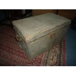 An old wooden box/Trunk having swing handles to either side and having applied fabric to the