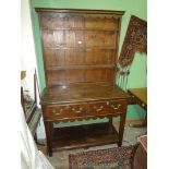 An appealing compact Oak pot board Welsh Dresser having fret-worked frieze and apron,