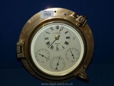 A contemporary Nauticalia, Fleet Commander time and weather station in a brass porthole case.