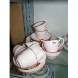A pink with gilt rim twenty-one piece Royal Vale bone china part Teaset to include six cups,