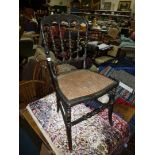 An elegant ebonised framed cane-seated Bedroom Chair,