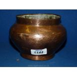 A Persian copper bowl finely engraved with repeated Islamic designs with a calligraphy frieze,