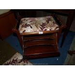 A piano Stool with drop down shelf for music and a matching Footstool.