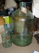 A large glass demi-john 21" tall and a smaller chemist's Jar, 11" tall.