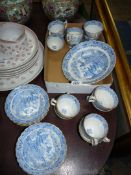 An oriental blue and white service having scalloped rimmed edging to include thirteen cups,