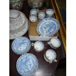 An oriental blue and white service having scalloped rimmed edging to include thirteen cups,