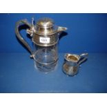 A silver plated 'Lemonade Holly Jug', 10 1/2" tall and a silver plated jug, 5" tall.