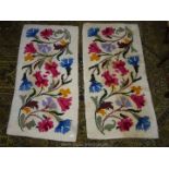 Two small white wool rugs with coloured flowers, some staining to one, 52 1/2" x 27".