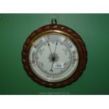 An aneroid Barometer with brass dial.